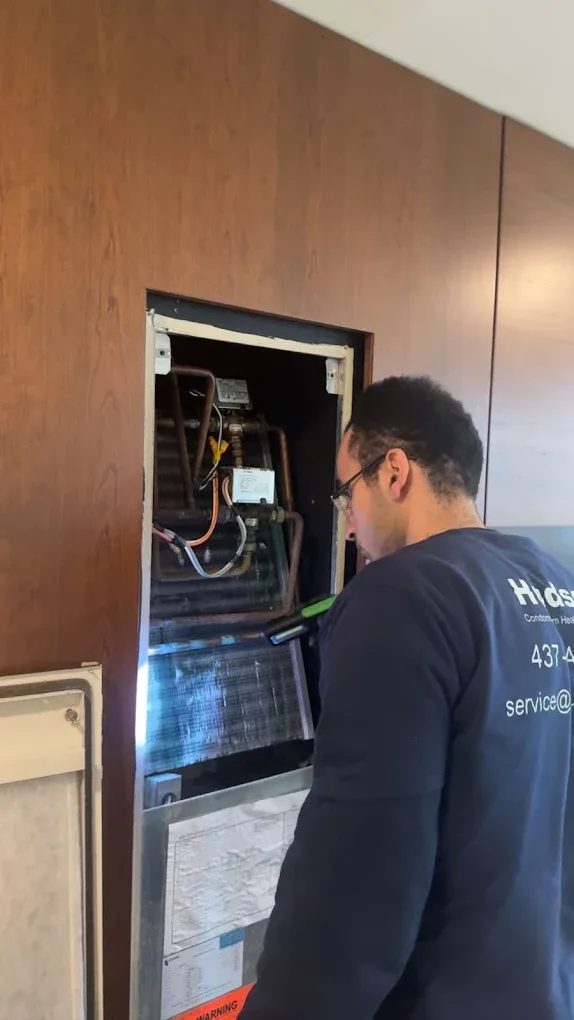 Hudson technician inspecting condo fan coil
